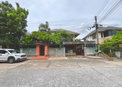  Front view of a residential house with garden and driveway