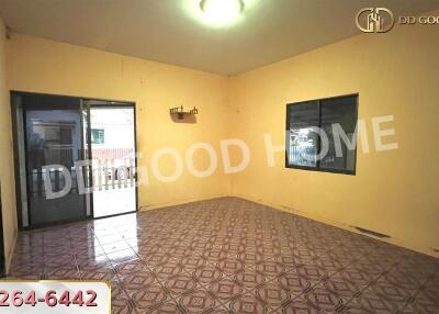 Spacious living room with tiled floor and large windows