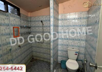 Bathroom with tiled walls and a shower area