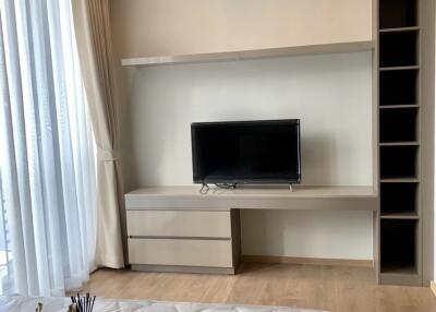 Modern bedroom with television and shelving unit