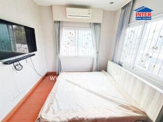 Modern bedroom with a wall-mounted TV and air conditioning