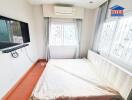 Modern bedroom with a wall-mounted TV and air conditioning