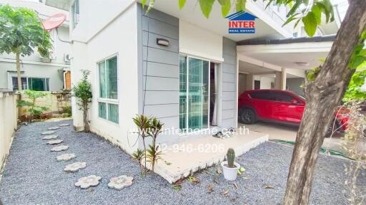 Exterior view of a modern house with garden and carport