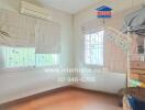 Bedroom with air conditioning, windows, and wooden floor