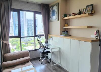 Cozy home office with a view of tall buildings