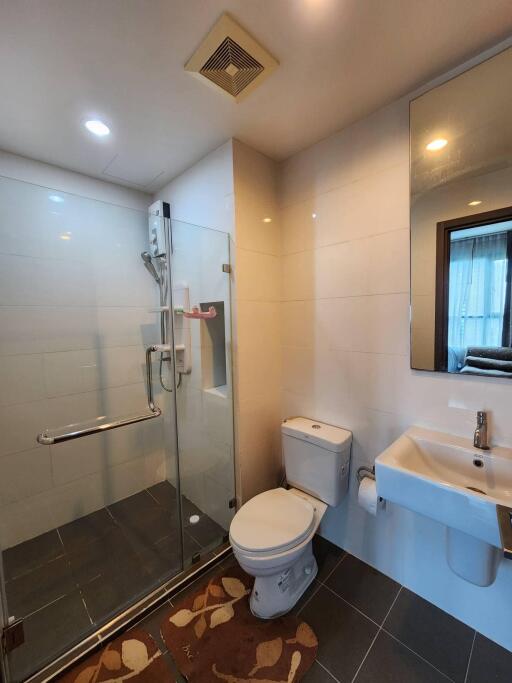 modern bathroom with shower, toilet, and sink