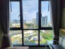 Bedroom with window overlooking city view