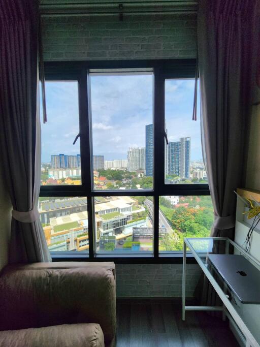 Bedroom with window overlooking city view