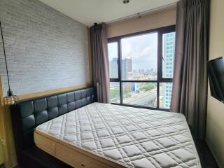 Modern bedroom with large windows and city view