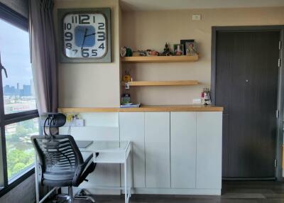 Home office with large clock and storage cabinets