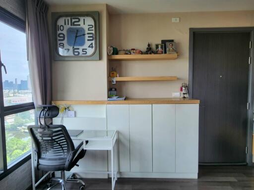 Home office with large clock and storage cabinets