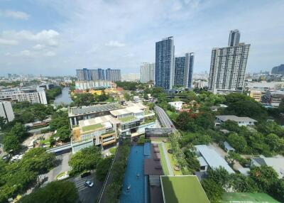 Aerial view of residential buildings and green spaces with a pool area
