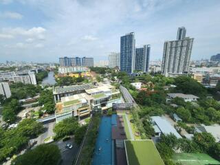 Aerial view of residential buildings and green spaces with a pool area