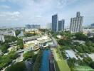 Aerial view of residential buildings and green spaces with a pool area