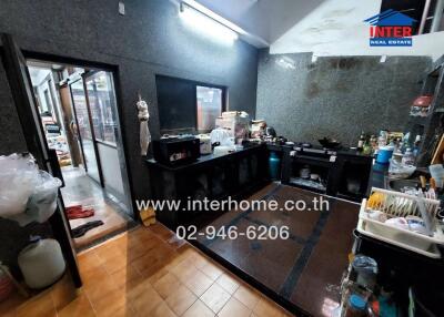 Modern kitchen with dark countertops and ample storage space