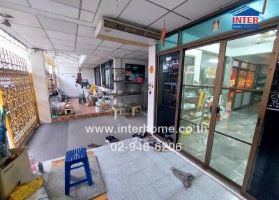 Indoor view of a mixed-use space with seating area and kitchen