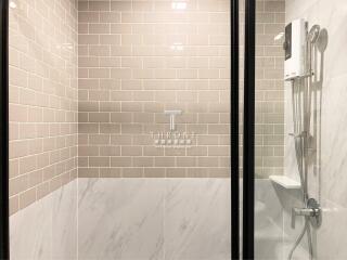 Modern bathroom with tiled shower area and glass door