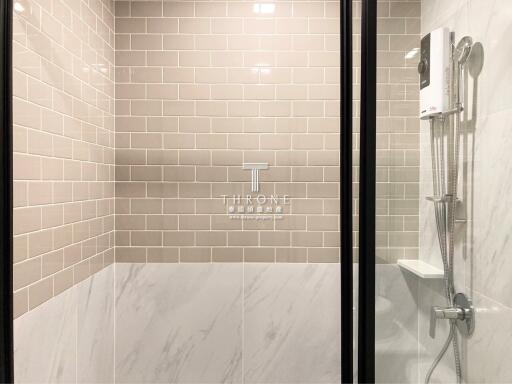 Modern bathroom with tiled shower area and glass door