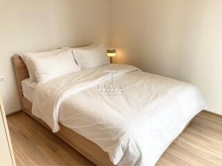 Modern bedroom with wooden flooring and comfortable bedding