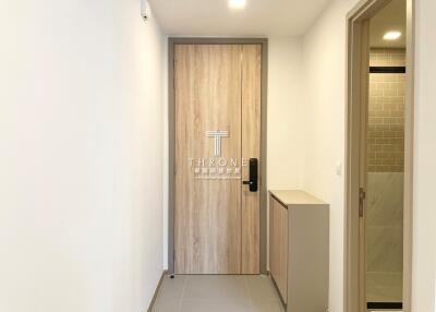 Entryway with wooden door and modern decor