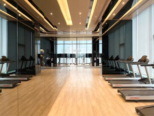 Modern gym facility with treadmills and large mirrors
