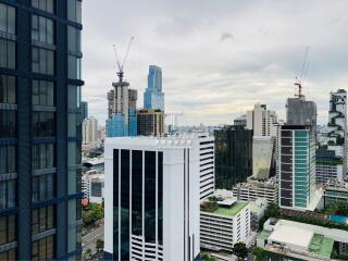 Cityscape view with high-rise buildings and construction cranes