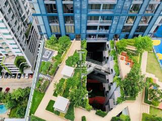 Aerial view of a modern residential building with rooftop gardens