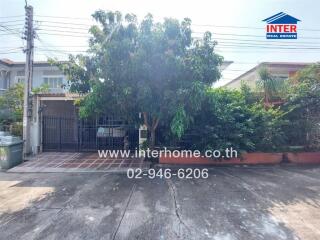 Front view of the house with trees and driveway