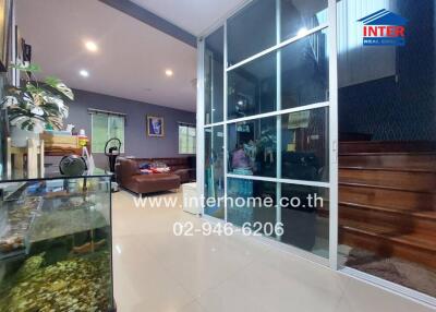 Spacious interior living area with modern glass partitions and comfortable seating