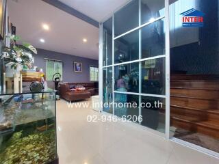 Spacious interior living area with modern glass partitions and comfortable seating