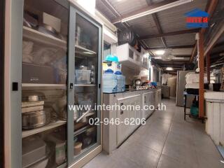 A view of a kitchen with appliances, storage cabinets, and water dispensers