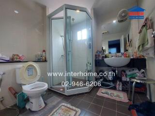 Bathroom with shower, toilet, sink, and storage