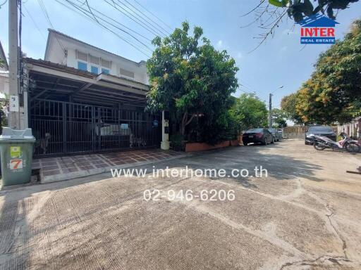 Photo of a house exterior with driveway and garden