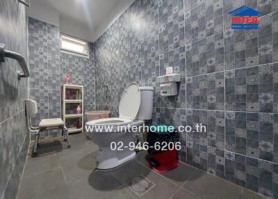 Bathroom with tiled walls and floor, toilet, and shelving