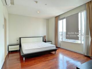 Bright and spacious bedroom with wooden flooring