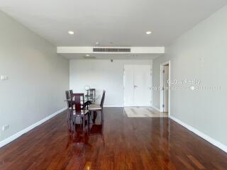 Spacious living room with wooden flooring and dining area