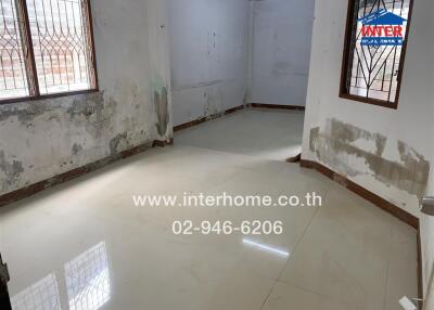 Room with tiled flooring and windows