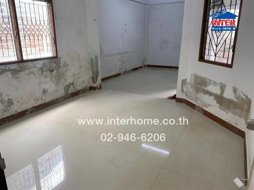 Room with tiled flooring and windows