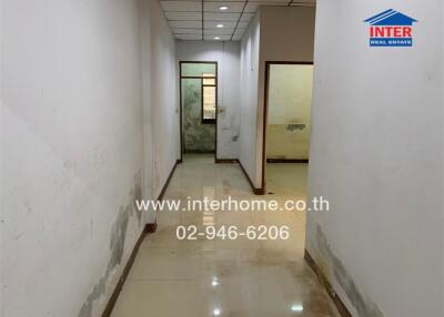 Hallway in a residential building with visible signs of wear