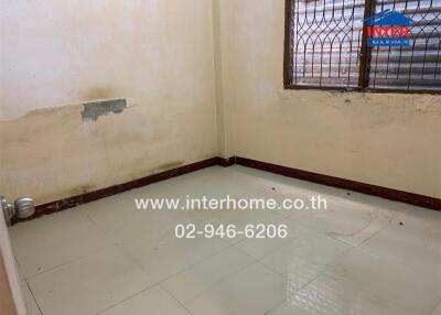 bedroom with tiled floor and barred window