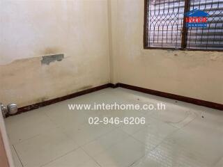 bedroom with tiled floor and barred window