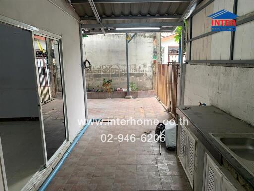 Covered outdoor space with sink and counter