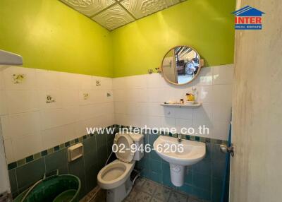 Bathroom with green and white walls