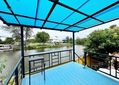 Blue-roofed outdoor patio overlooking a river