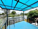 Blue-roofed outdoor patio overlooking a river