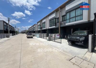 Street view of modern townhouses with driveways