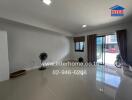 Spacious living room with modern tiled flooring and natural light