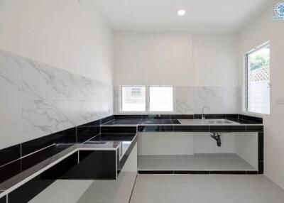 Minimalist modern kitchen with large sink and marble backsplash