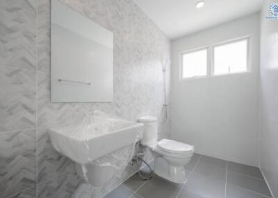 Modern bathroom with large mirror and natural lighting