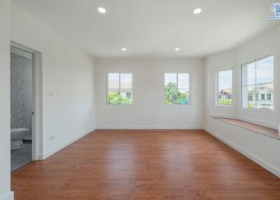 Bright and spacious empty living room with large windows and hardwood floors